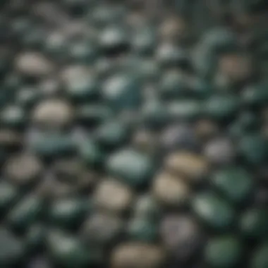 A close-up of various dark green stones showcasing their unique textures.