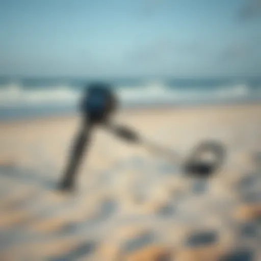 A sleek, modern metal detector resting on a sandy beach